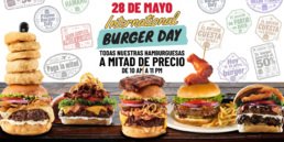 P&oacute;ster promocional del International Burger Day en TGI Fridays Tijuana para el 28 de mayo. Texto central: Todas nuestras hamburguesas a mitad de precio de 10 AM a 11 PM. Muestra varias hamburguesas con ingredientes frescos, aros de cebolla y costillas.